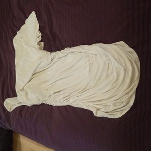 Asymmetrical cream coloured top. Large, gathered sides.